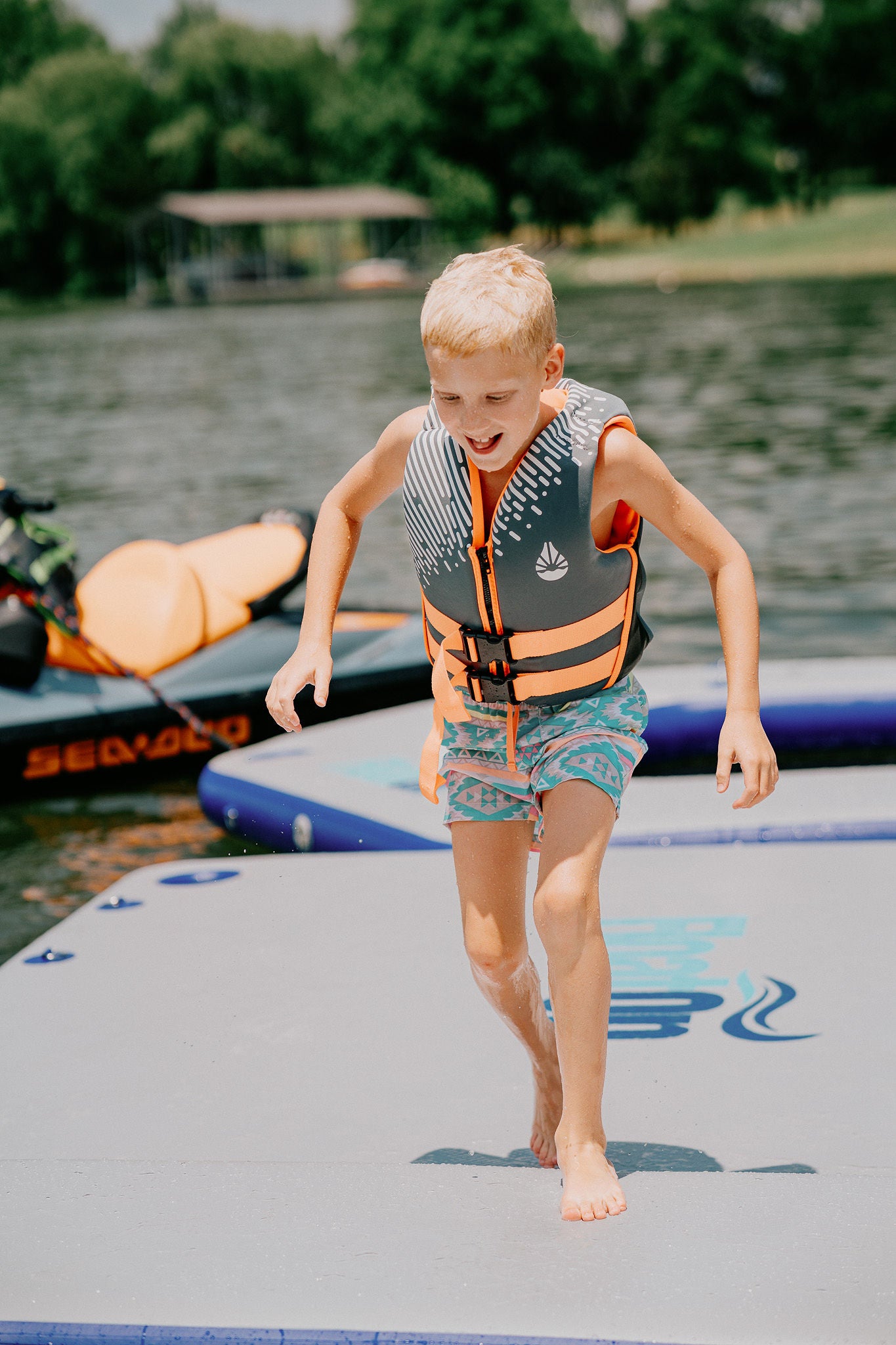 A child walking on the low tide floating dock in the middle of the water.