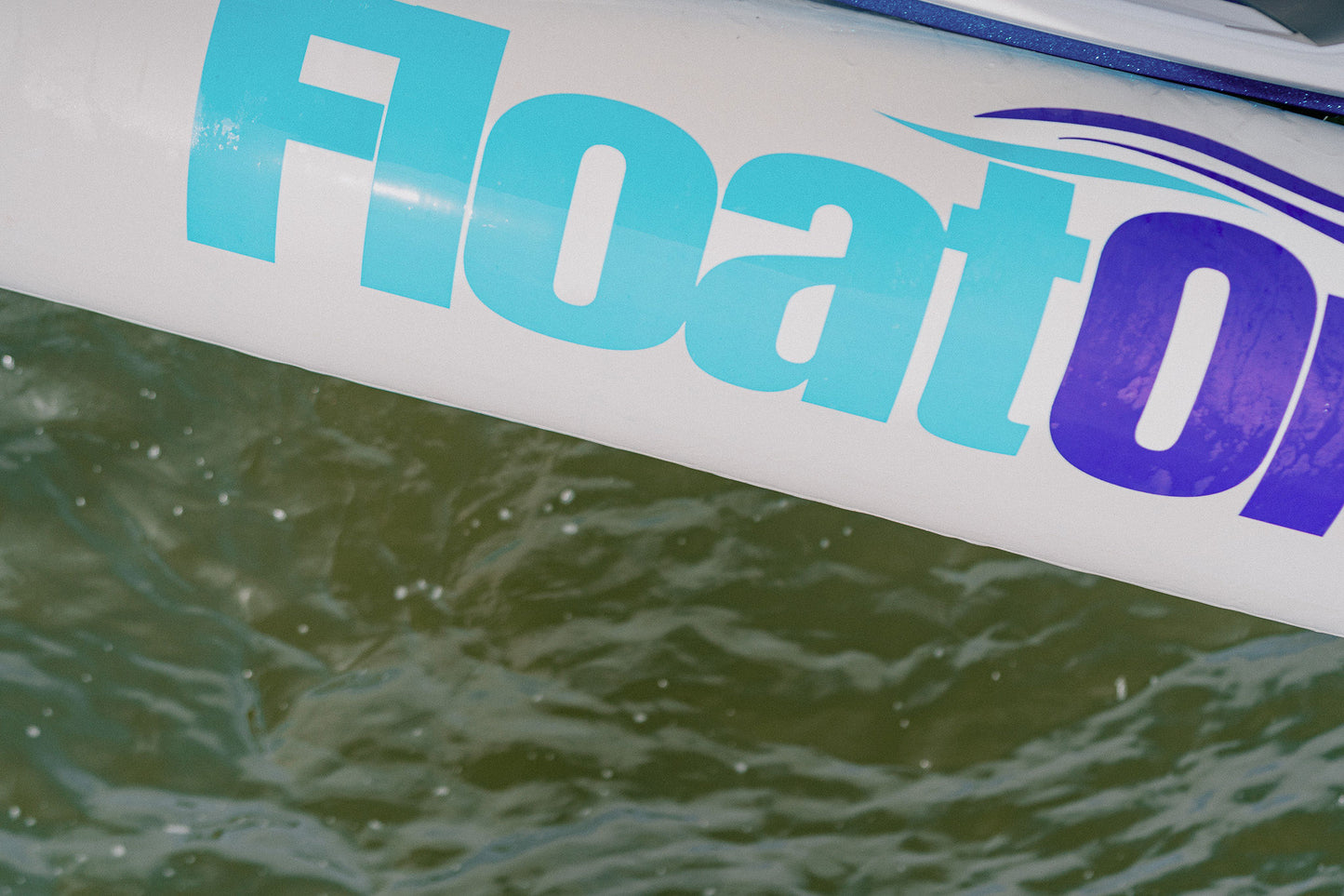 A close up view of the Tide Guard inflatable boat fender by Float On at the lake.