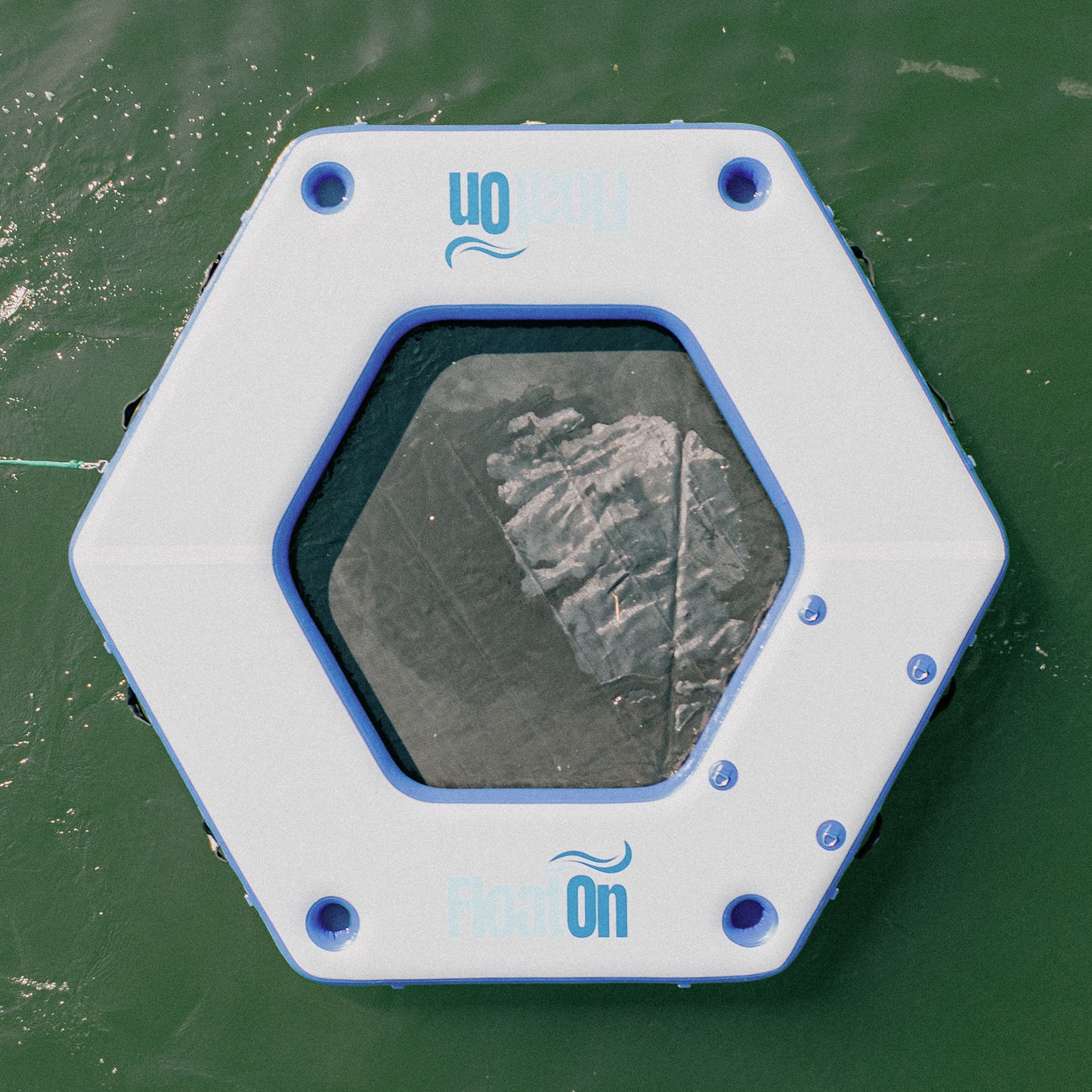 The Grand Oasis inflatable water mat floating on the lake.
